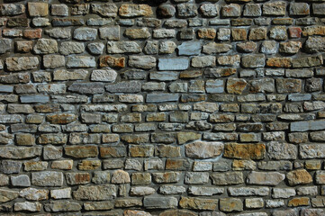 Medieval fortress wall: Impressive stone masonry adorned with battlements, towers, and arrow slits,...