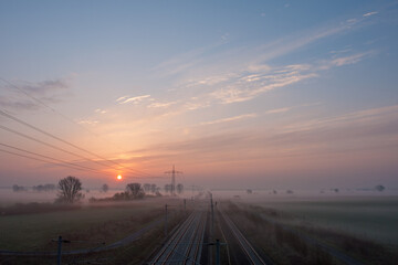 Early morning in Elbe-Havel-Land, Germany, unveils tranquil landscapes painted with soft hues, as mist gently rises over the meandering river.