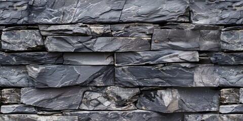 Raw Beauty: A rough-textured black stone wall, showcasing the untamed elegance of nature's creations.