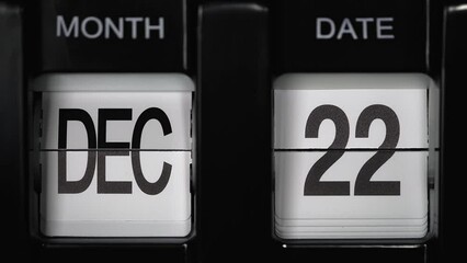 retro flip calendar with date change from the twenty first of December to the twenty-second of December. daily calendar with change of days of the month. calendar concept, reminders, events. close up.