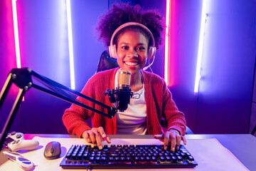 Host channel of gaming streamer, African girl taking, typing with Esport skilled team player and...
