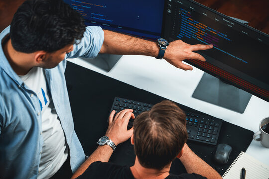 IT developers discussing online software development information on pc screen, creating program coding for latest version application on website. Concept of brainstorming firmware updated. Sellable.