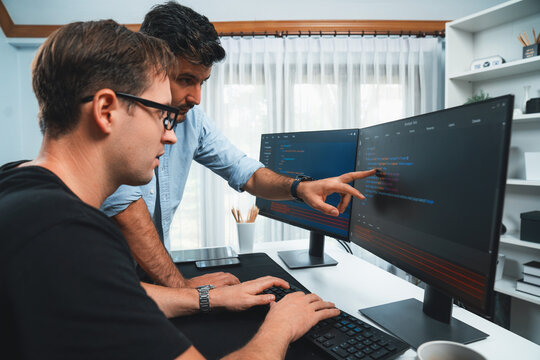 IT developers pointing on software development information on two screens with coding program in application and website. Technical engineer coder analyzing in safety program concept. Sellable.