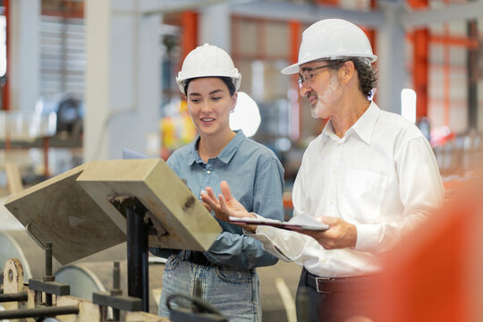 Portrait of Two Professional Engineers Use Industrial Digital Tablet to Work with Augmented Reality. Great Template Shot for Augmented Reality. Factory Workshop.  engineer man and woman manager leader