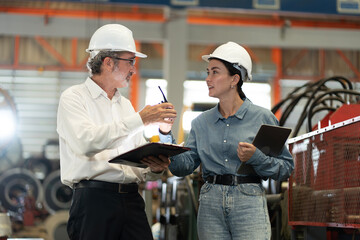 two professional engineer,worker,technician use clipboard discuss work, walk in steel metal...