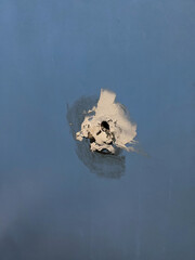 rubber glue on blue wooden wall