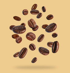 Roasted coffee beans falling on beige background