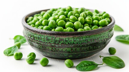 Bowl of peas and spinach leaves on white surface
