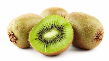 One kiwi fruit sliced in half on the ground