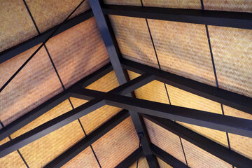 Roof interior design with black metal construction and handmade bamboo weaving mat for modern,tropical and Bali style decorations. Selective focus