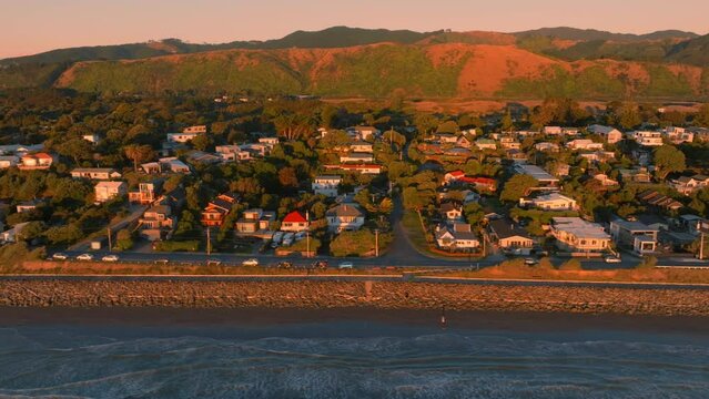 Aerial: Houses along Paraparaumu beach at sunset, wellington, New Zealand.