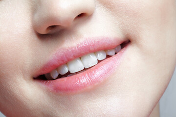 Female human mouth and nose. Macro portrait of smiling woman face with no makeup.