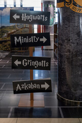 Obraz premium Sign with direction arrows Hogwarts Ministry Gringotts Azkaban at the themed section of the National Library of El Salvador (BINAES).