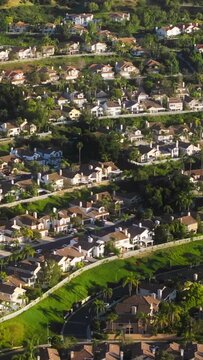 Vertical video. Natural scenery of Luxury property called Calabasas hills settled in green area, Los Angeles suburban, USA. Aerial view of Calabasas Park estate at sunset.Wealthy Calabasas real estate