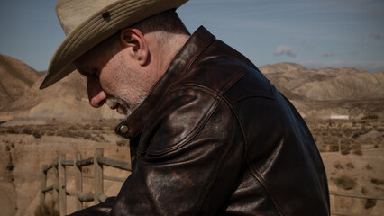 Side view of adult man in cowboy hat