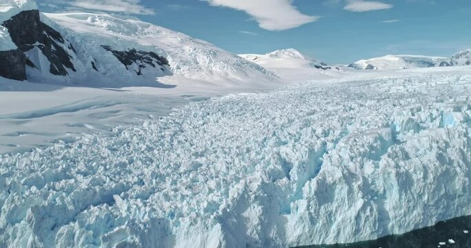 Aerial of ice glacier at ocean bay. Environment preserve from global warming and climate change. Melting ice and snow at nobody arctic landscape. Majestic nature of Antarctica at panorama drone shot