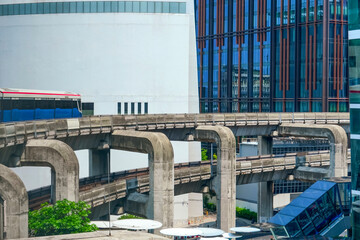 Urban view railway tracks suburban subway electric trains rushing on bridge overpass supports...