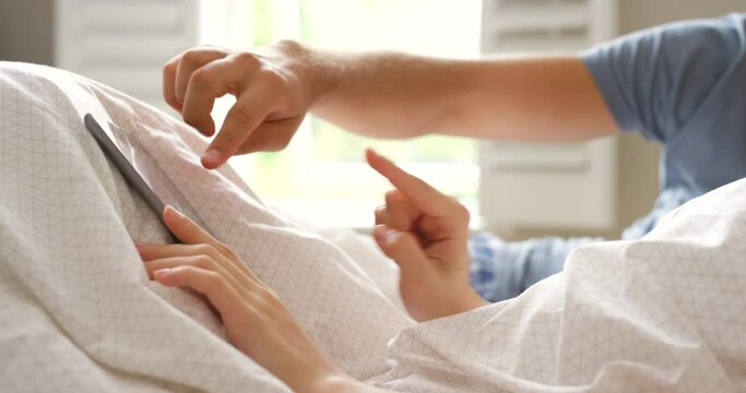 Couple, hands and tablet in bedroom for streaming multimedia, relax and love with search for online movie. People, scroll and touchscreen in closeup on digital technology and weekend for subscription