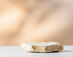 Stone podium beige concept with blurred background with light shadow