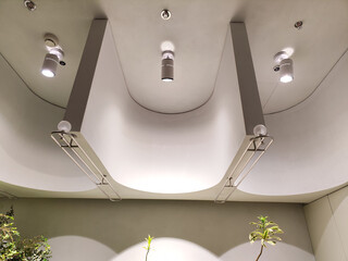 Ceiling with bright lights in a modern warehouse, shopping center building, office or other commercial real estate object.