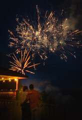



Wait for the previous results.  This one is bigger and better
Young African American man hugging his white girlfriend while watching Fourth of July fireworks from observation deck over river