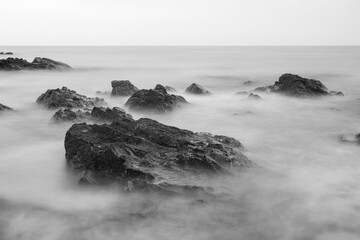 Long exposure black and white photos of coastline scenery.
