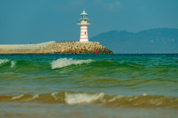 Red lighthouse in the sea.