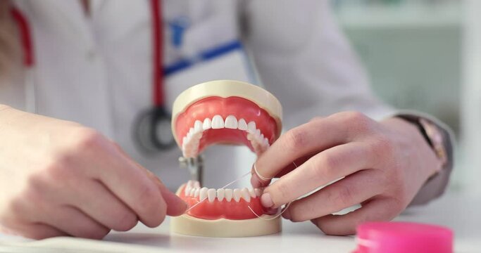 Dentist shows how to properly brush your teeth with floss