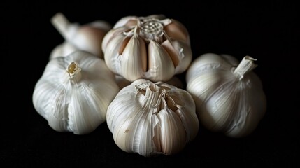Close-up of fresh garlic cloves, emphasizing the health-promoting compound allicin, ideal for health awareness, isolated background, studio lighting