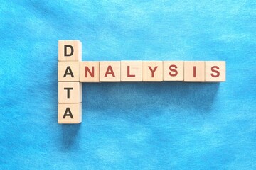 Data Analysis concept. Crossword puzzle flat lay in blue background.	