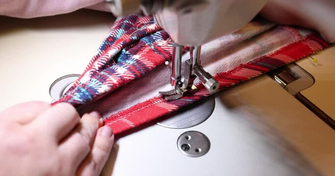 Work of an experienced tailor sews high quality handmade clothes in a tailoring workshop