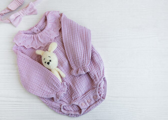 Pink  bodysuit with toy knitted toy and headband. Set of baby clothes and accessories summer on...