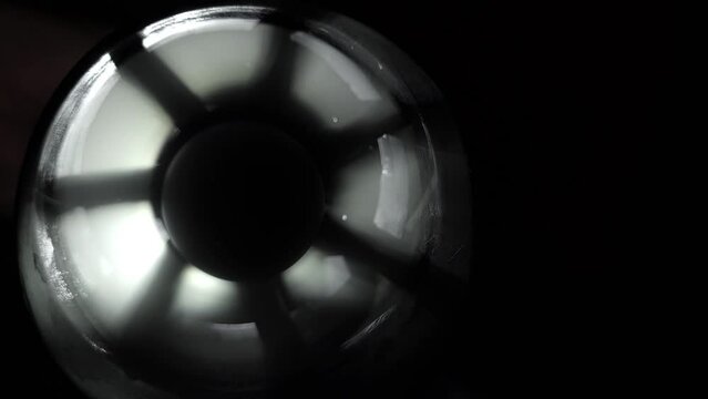 Ventilator in darkness on left, background b-roll with free space for text on right, close-up.