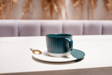 Ceramic cup with coffee on white table. Hot drinks concept