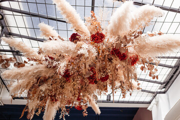 Natural eco decor made of dried flowers in the interior view from below. Stylish decorations for interiors and homes.