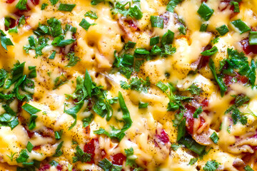The surface of a pizza with cheese. Pizza with cheese and herbs close-up.