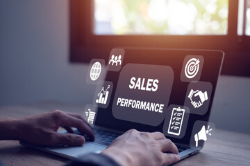 Sales performance management concept Businessman uses laptop to analyze data and sales performance...