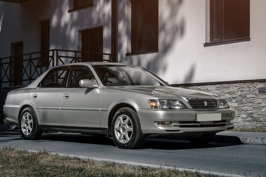 Novosibirsk, Russia - April    23, 2024 :   silver Toyota Cresta   parked  against the backdrop of   city