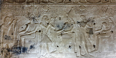 Wall relief in the Chapel sanctuary of Horus shows King Seti offering incense to the God Horus in...