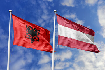 3d illustration. Albania and Austria Flag waving in sky. High detailed waving flag. 3D render. Waving in sky. Flags fluttered in the cloudy sky.