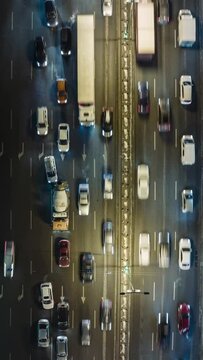 Traffic jam at rush hour. Aerial top down view of many cars on the road. Time lapse, Vertical Screen