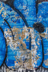 Blue and red graffiti on wall. Abstract detailed wall texture with blue graffiti paint.