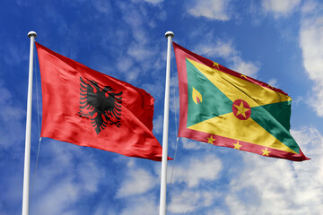 3d illustration. Albania and Grenada Flag waving in sky. High detailed waving flag. 3D render. Waving in sky. Flags fluttered in the cloudy sky.
