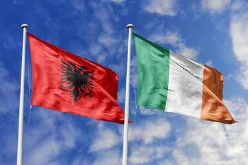 3d illustration. Albania and  Ireland Flag waving in sky. High detailed waving flag. 3D render. Waving in sky. Flags fluttered in the cloudy sky.