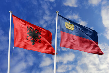 3d illustration. Albania and Liechtenstein Flag waving in sky. High detailed waving flag. 3D render. Waving in sky. Flags fluttered in the cloudy sky.
