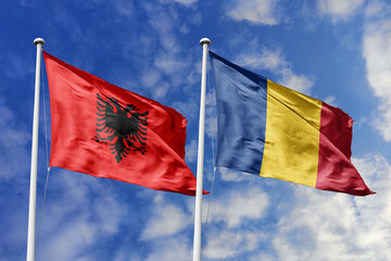 3d illustration. Albania and Romania Flag waving in sky. High detailed waving flag. 3D render. Waving in sky. Flags fluttered in the cloudy sky.