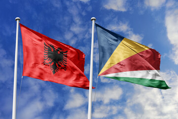 3d illustration. Albania and Seychelles Flag waving in sky. High detailed waving flag. 3D render. Waving in sky. Flags fluttered in the cloudy sky.