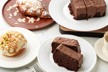 Homemade desserts sponge cake and cinnamon bun on table