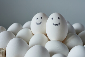 Eggs with smiley faces on white background. Close up.