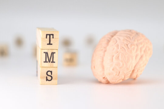 TMS Acronym Transcranial magnetic stimulation concept with brain on white background